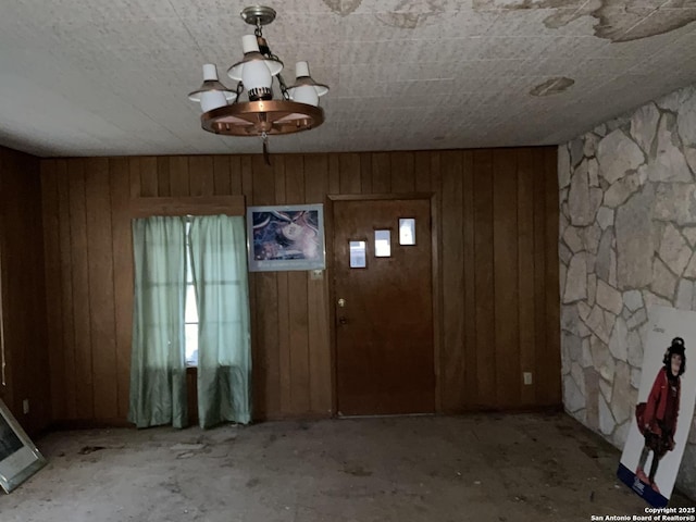 foyer entrance with wood walls