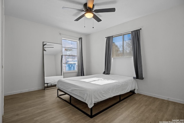 bedroom with ceiling fan and hardwood / wood-style flooring