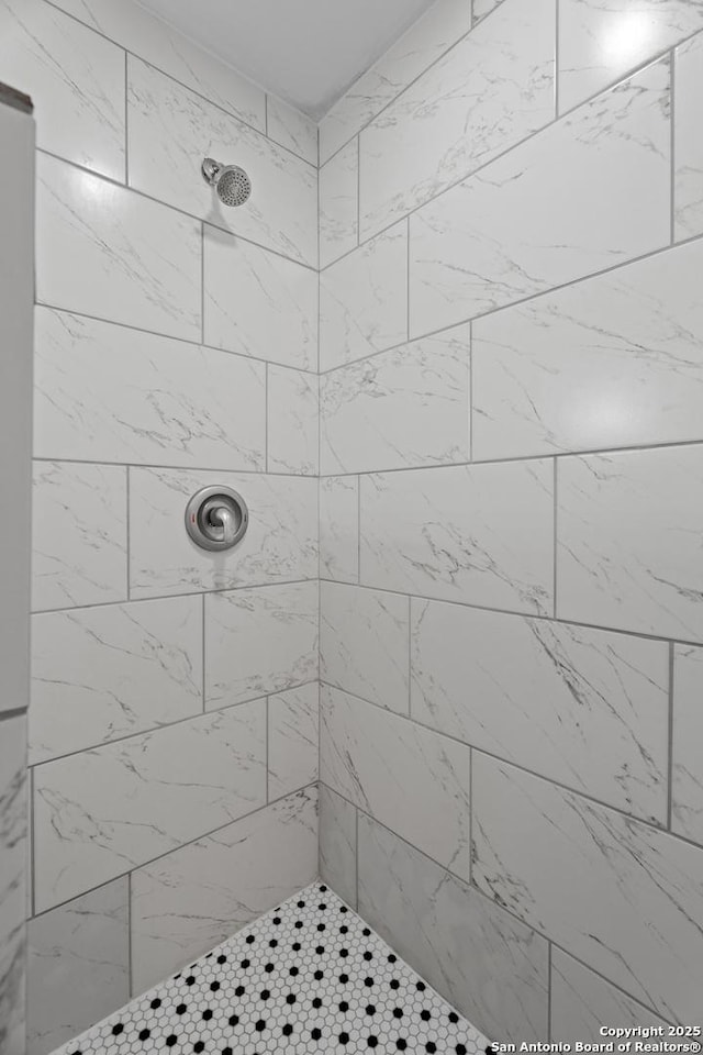 bathroom with tiled shower