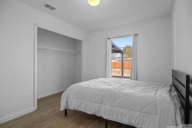 bedroom featuring dark hardwood / wood-style floors and a closet