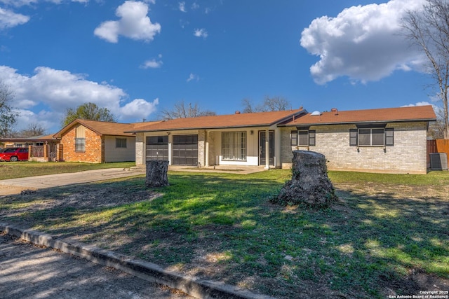 single story home with a front yard and central air condition unit