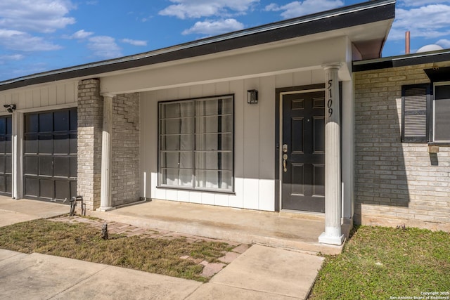 entrance to property with a porch and a garage