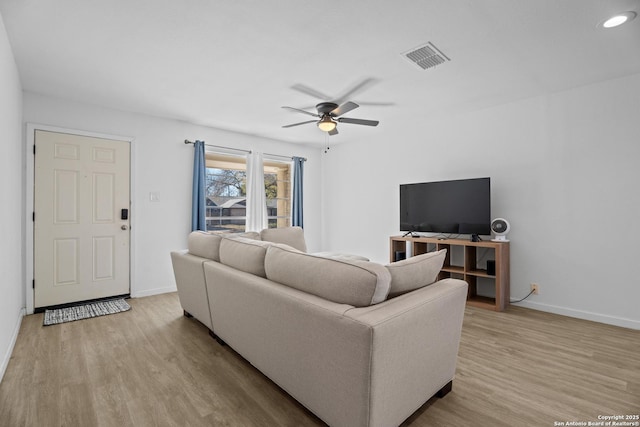 living room featuring ceiling fan and light wood-type flooring