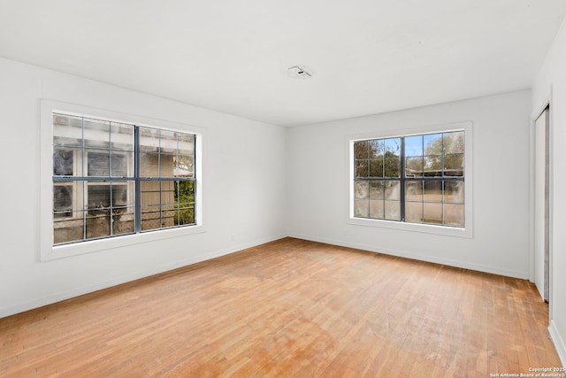 empty room with hardwood / wood-style flooring