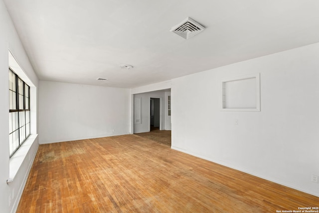 spare room featuring hardwood / wood-style floors