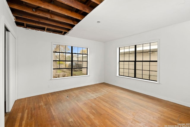 interior space with beam ceiling and light wood-type flooring