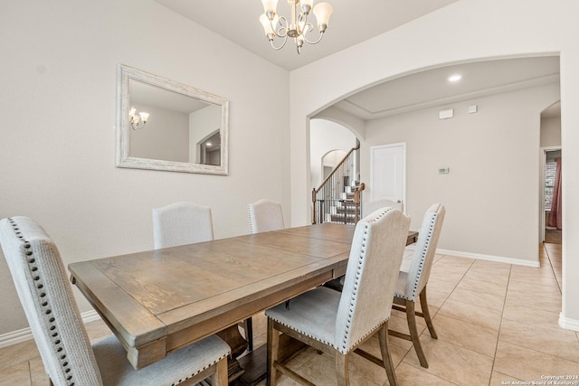 dining room featuring light tile patterned floors and a chandelier