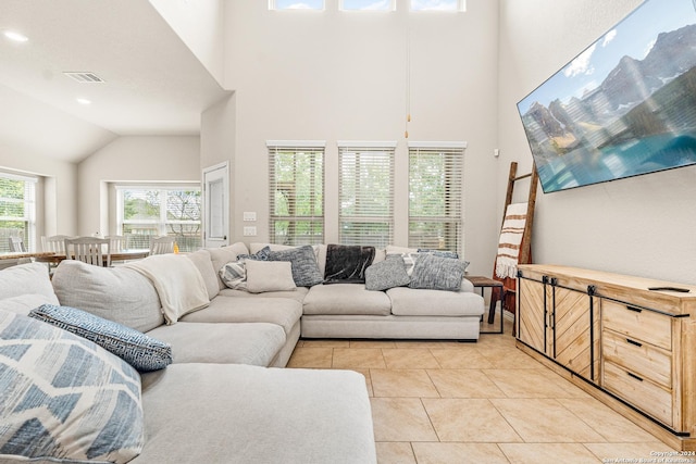 tiled living room with high vaulted ceiling