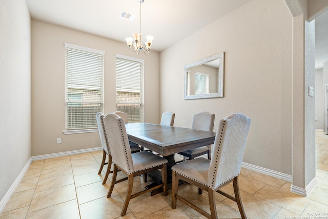 dining room featuring light tile patterned floors and a chandelier