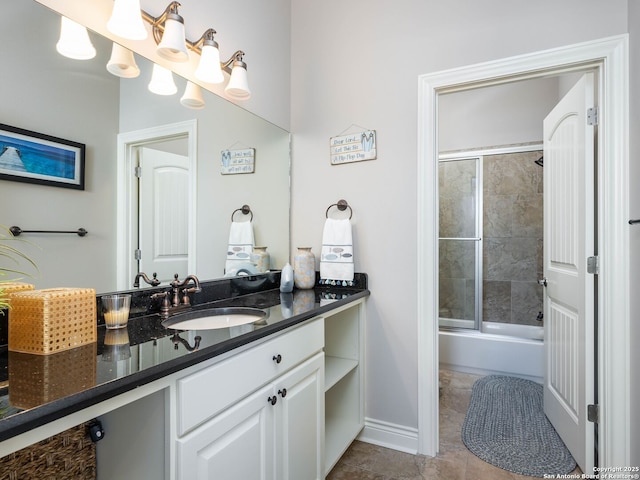 bathroom featuring tile patterned floors, vanity, and shower / bath combination with glass door