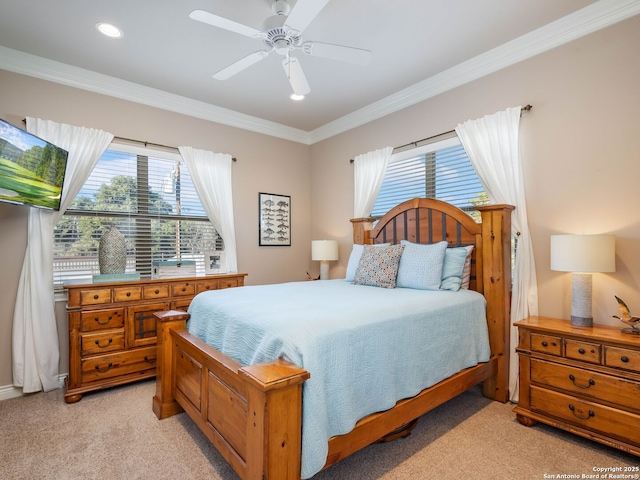 carpeted bedroom featuring ceiling fan and crown molding