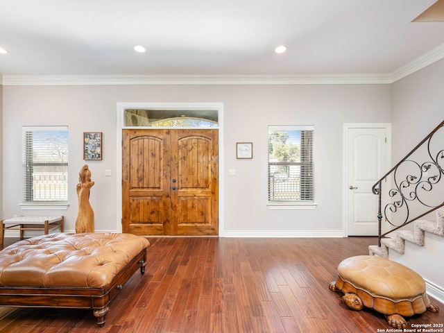 entrance foyer with wood-type flooring and ornamental molding