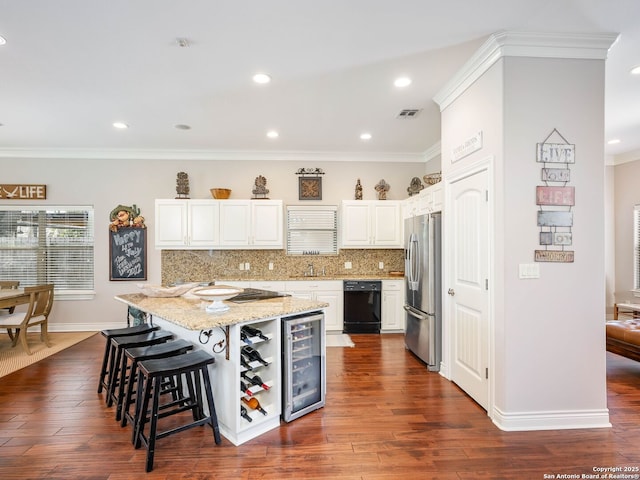 kitchen featuring a center island, white cabinets, light stone counters, dark hardwood / wood-style flooring, and stainless steel refrigerator