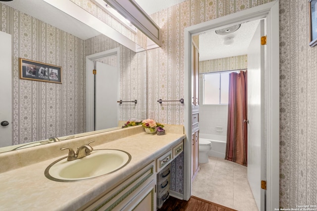 111 Austin Dr S, Boerne, TX 78006 - bathroom with toilet, shower / tub combo with curtain, vanity, wood finished floors, and wallpapered walls