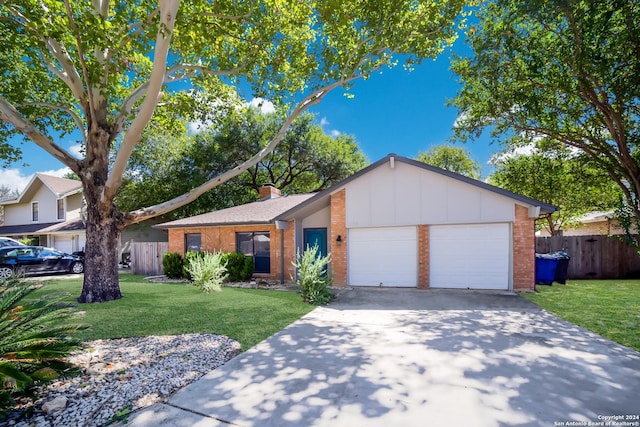 ranch-style home featuring a garage and a front lawn