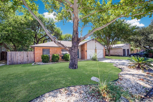 single story home with a garage and a front lawn