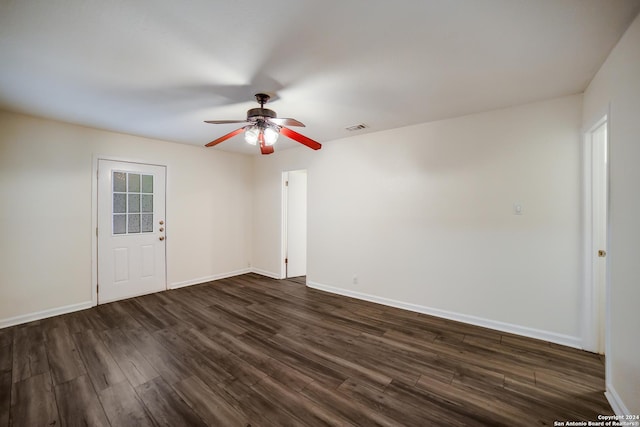 spare room with ceiling fan and dark hardwood / wood-style flooring