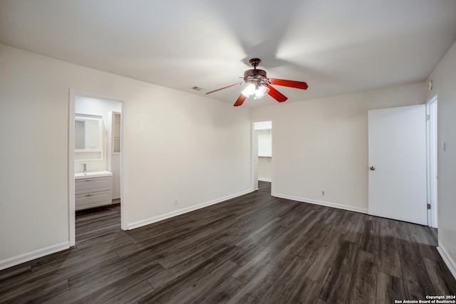 empty room featuring ceiling fan and dark wood-type flooring