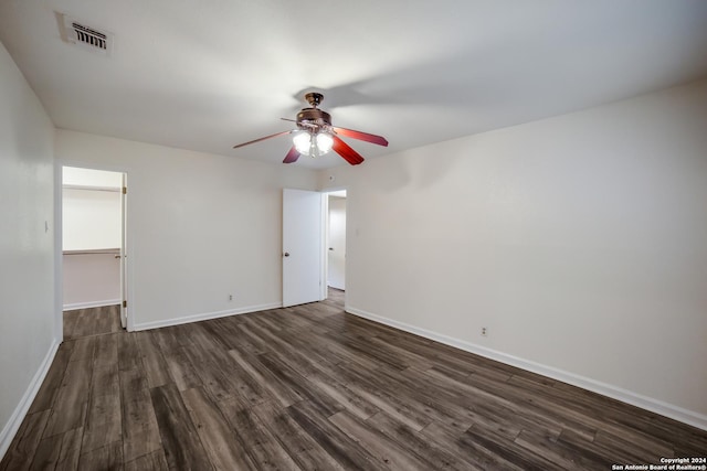 empty room with ceiling fan and dark wood-type flooring