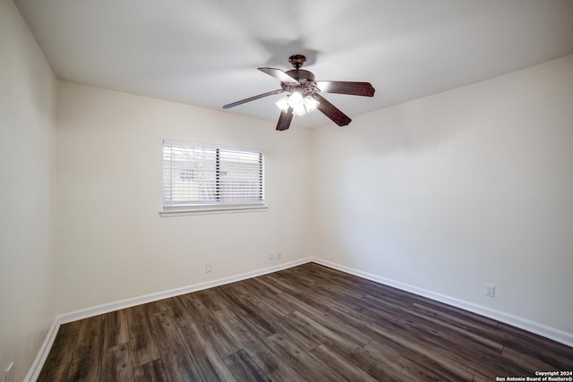 spare room featuring dark hardwood / wood-style flooring and ceiling fan