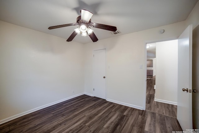 unfurnished bedroom featuring ceiling fan, dark hardwood / wood-style floors, and a closet