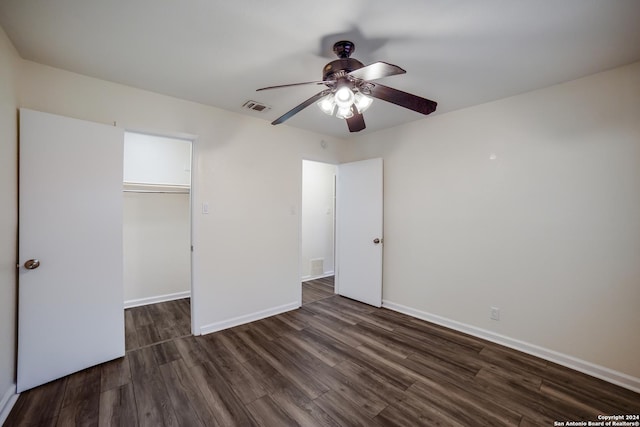 unfurnished bedroom with ceiling fan, dark hardwood / wood-style floors, and a closet