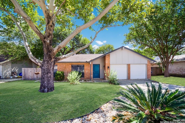 ranch-style house featuring a front yard and a garage