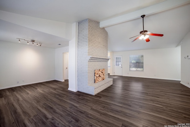 unfurnished living room featuring vaulted ceiling with beams, dark hardwood / wood-style floors, a brick fireplace, and ceiling fan