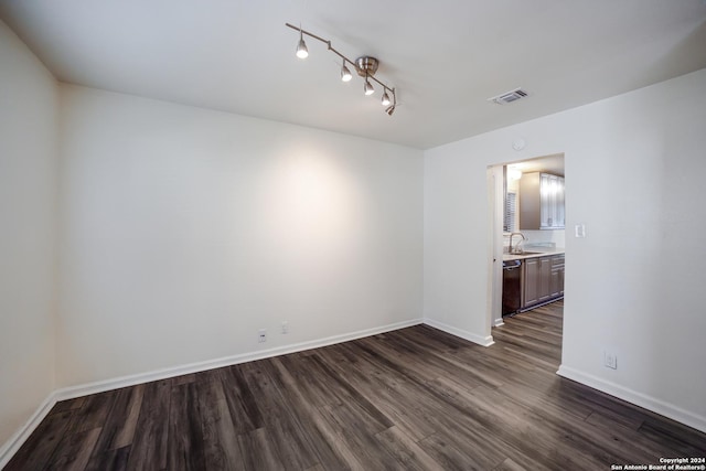 spare room featuring dark hardwood / wood-style floors and sink