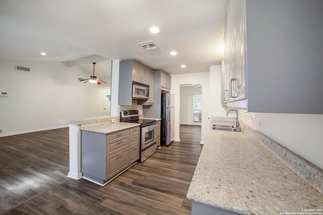 kitchen featuring sink, vaulted ceiling, ceiling fan, kitchen peninsula, and stainless steel appliances