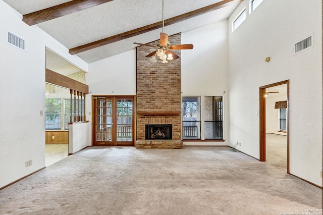 unfurnished living room featuring ceiling fan, beamed ceiling, high vaulted ceiling, and light colored carpet