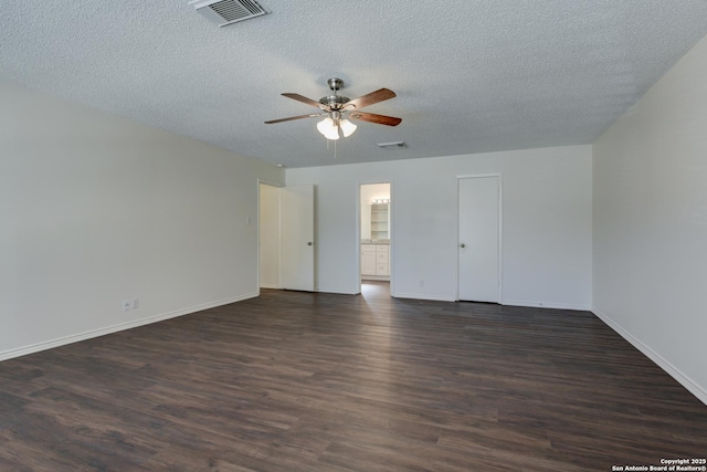 empty room with a textured ceiling, dark hardwood / wood-style floors, and ceiling fan