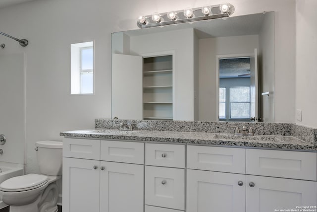 full bathroom featuring bathing tub / shower combination, toilet, vanity, and a healthy amount of sunlight