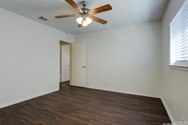 unfurnished room with ceiling fan, dark hardwood / wood-style floors, and a textured ceiling