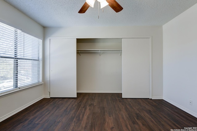 unfurnished bedroom featuring a closet, ceiling fan, dark hardwood / wood-style floors, and a textured ceiling