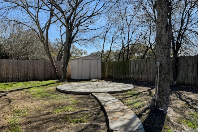 view of yard featuring a patio and a shed