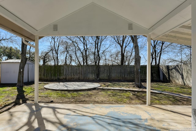 view of patio featuring a storage unit