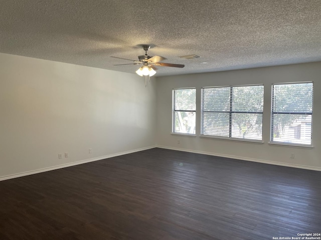 empty room featuring a textured ceiling, ceiling fan, and dark hardwood / wood-style flooring