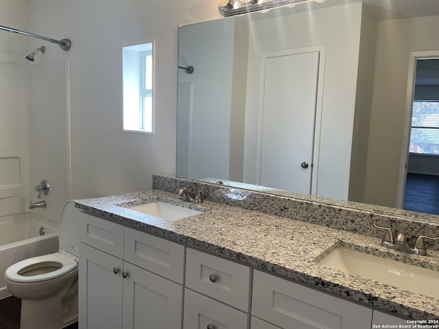 full bathroom featuring shower / bath combination, toilet, vanity, and a healthy amount of sunlight