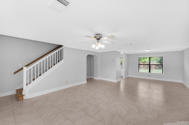 unfurnished living room featuring ceiling fan and ornamental molding