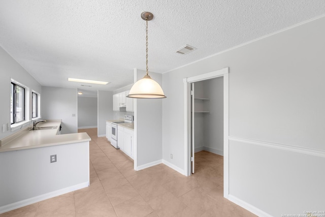 kitchen with white cabinetry, electric range, sink, pendant lighting, and a textured ceiling