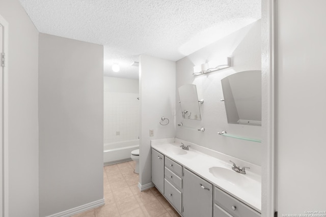 full bathroom featuring  shower combination, vanity, a textured ceiling, and toilet