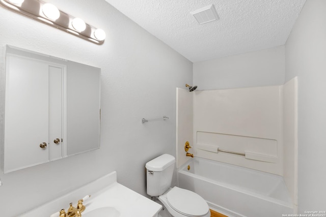 full bathroom with shower / tub combination, vanity, a textured ceiling, and toilet