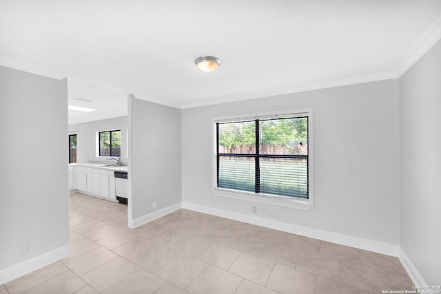 unfurnished room with sink, light tile patterned flooring, and ornamental molding