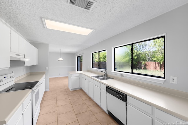 kitchen with white appliances, white cabinets, sink, hanging light fixtures, and light tile patterned floors