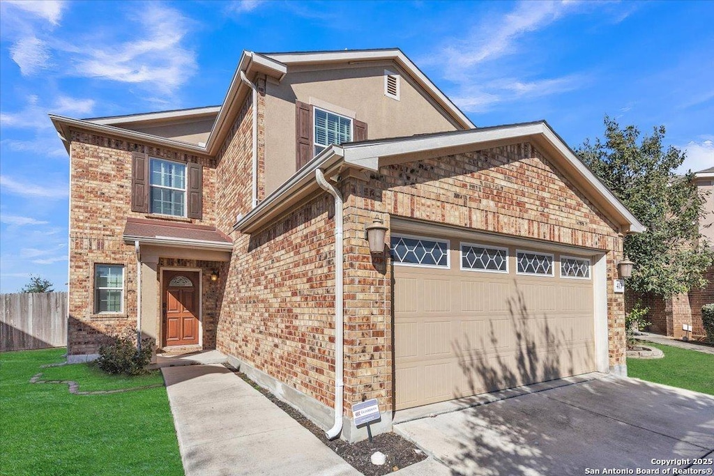 front facade with a garage and a front lawn