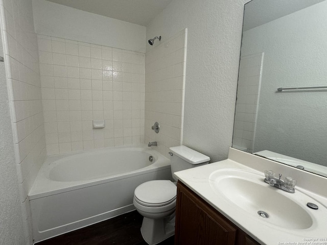 full bathroom featuring shower / bathing tub combination, vanity, toilet, and hardwood / wood-style flooring