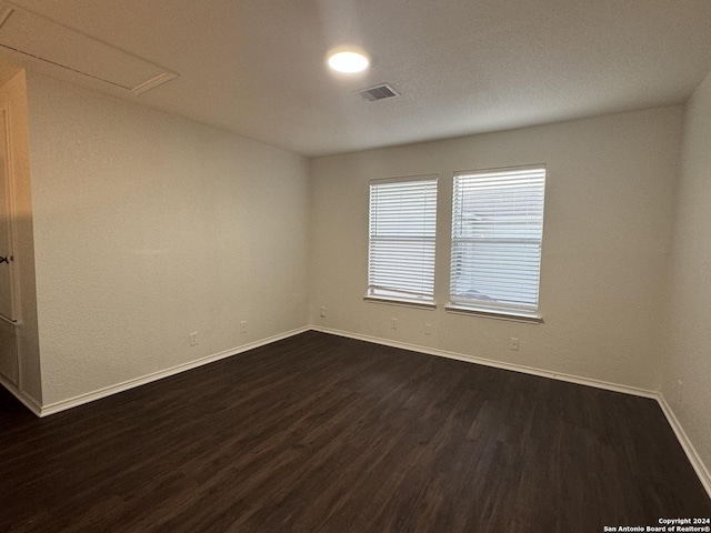 unfurnished room featuring dark hardwood / wood-style flooring