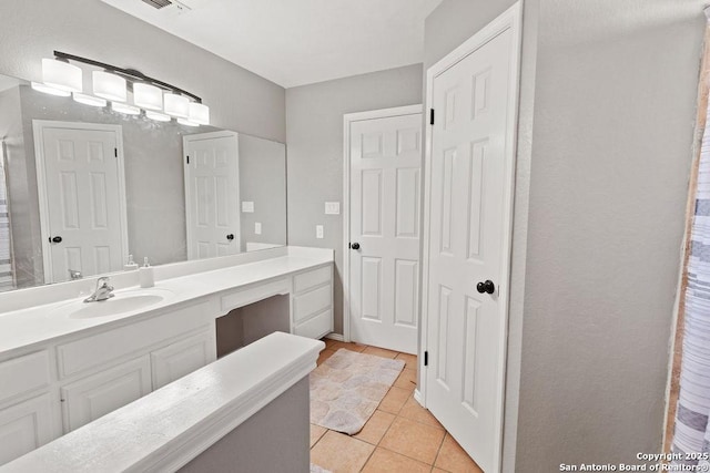 bathroom with tile patterned flooring and vanity