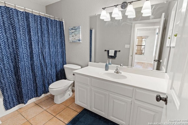 bathroom featuring toilet, vanity, and tile patterned floors